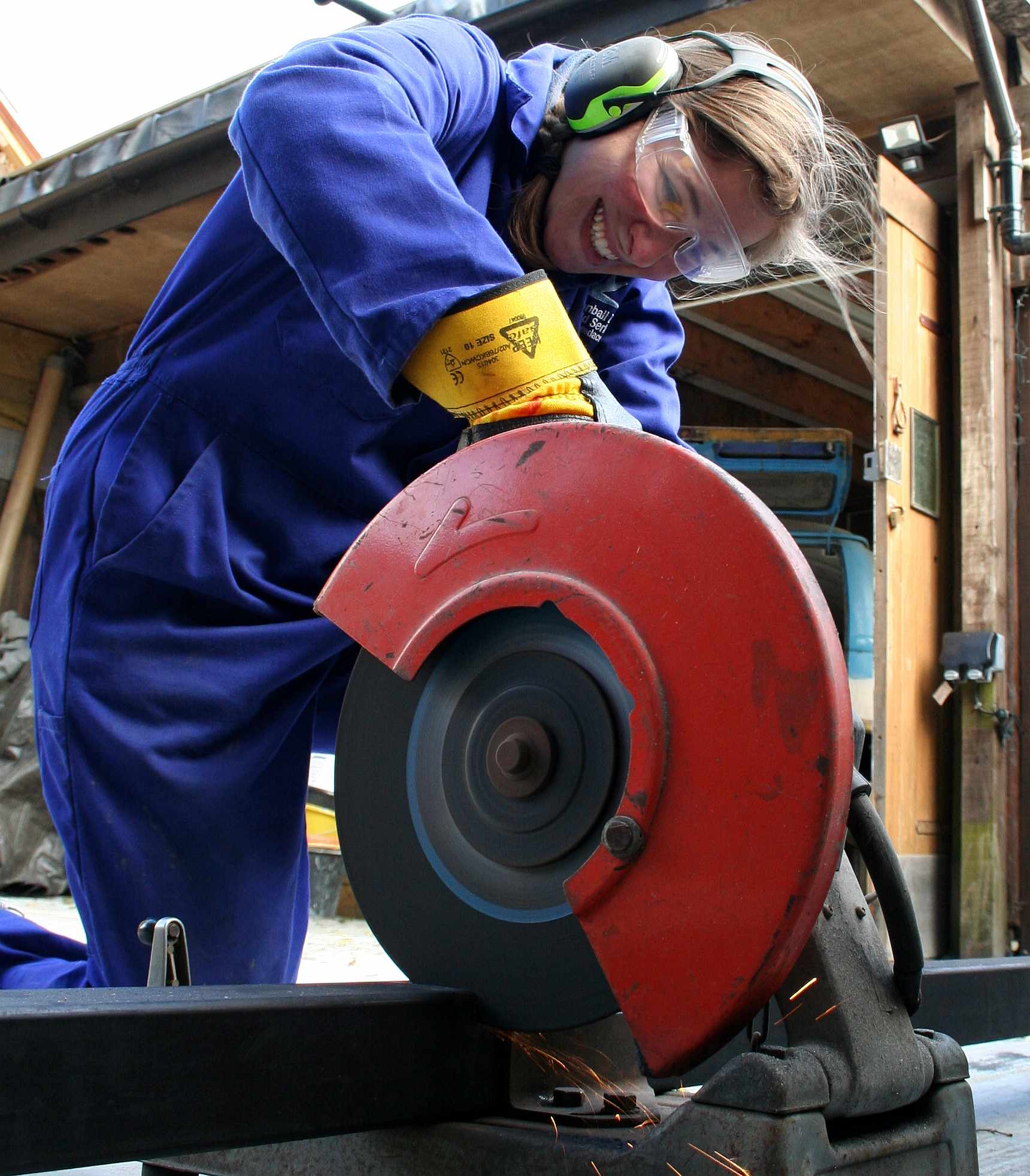 Lolita using a disc chop saw to cut steel tubing