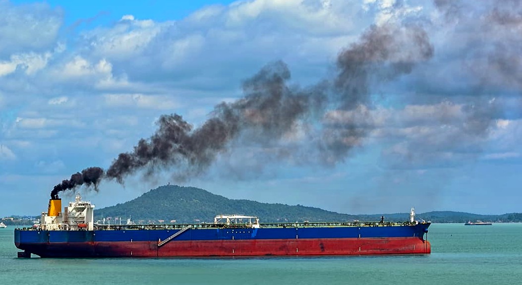Heavy diesel oil powered cargo ship spewing black carbon and sulfur