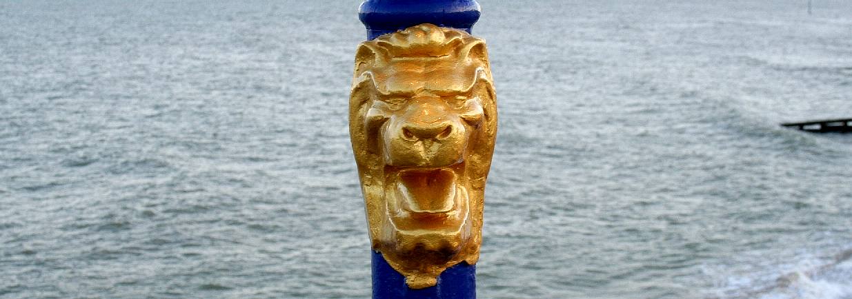 Golden painted lion lamp post on Eastbourne Pier