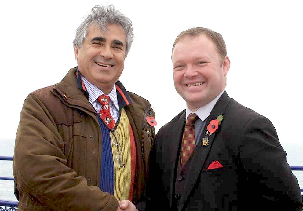 Abid Gulzar and Brett Mclean shake hands on Eastbourne Pier