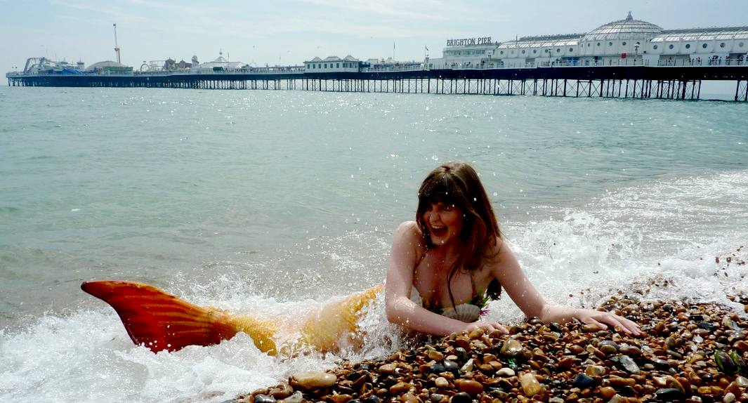 A mermaid on the beach at Brighton, near the Palace Pier