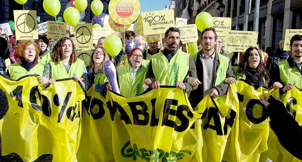 Greenpeace marchers demanding 100% renewable energy by 2020